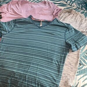 Three Lululemon T-shirts.